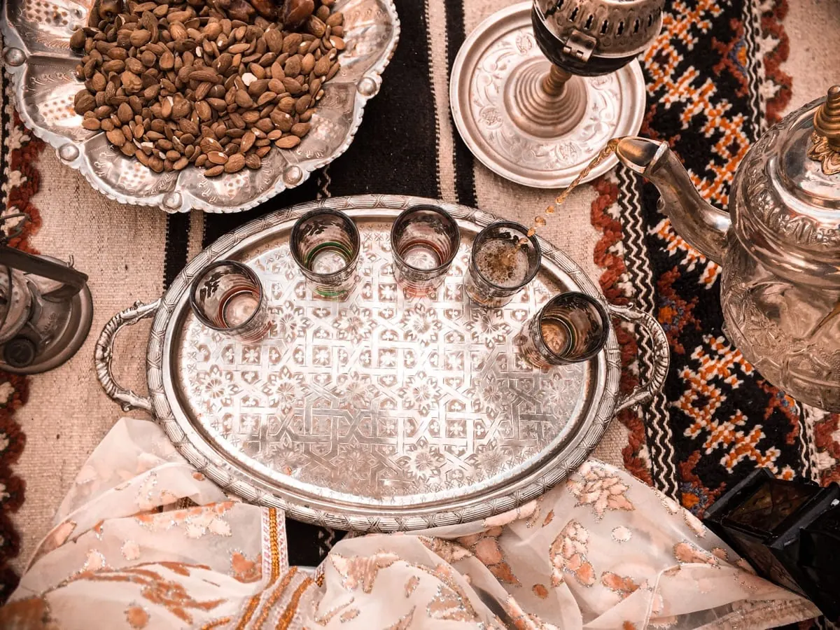 Traditional tea being poured into glasses