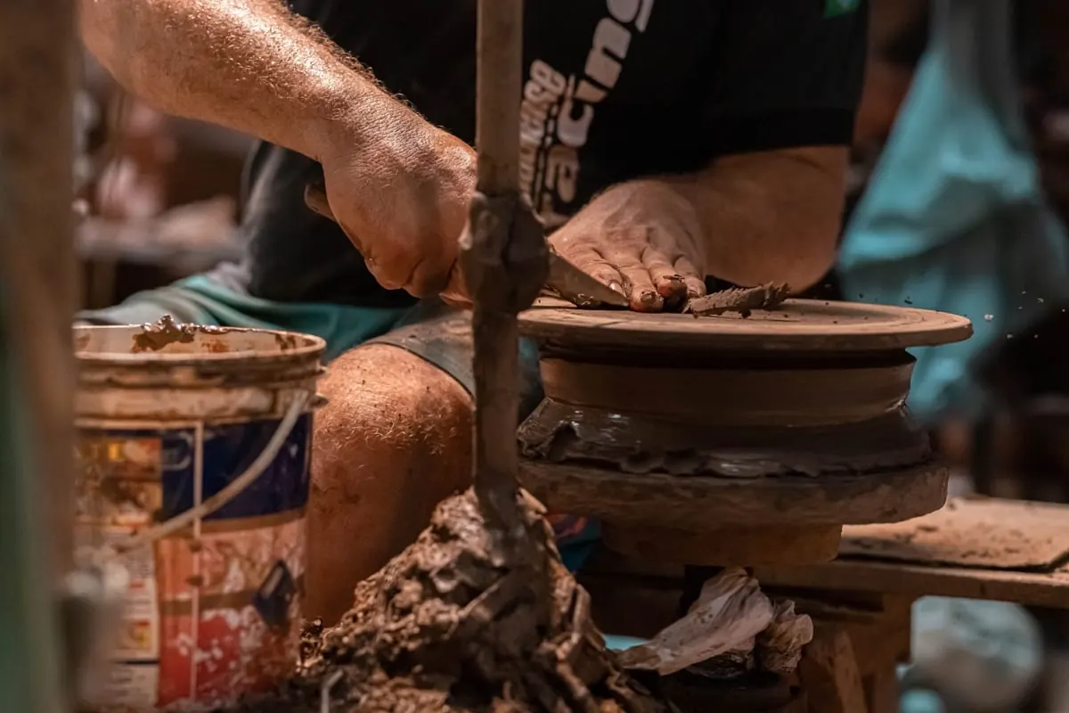 An artisan shaping clay on a pottery wheel